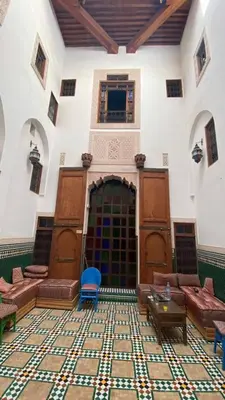 a large room with couches and tables in a building at Riad Alfredo in Fès