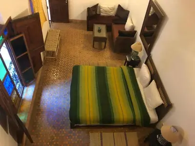 an overhead view of a bedroom with a bed and a couch at Riad Alfredo in Fès