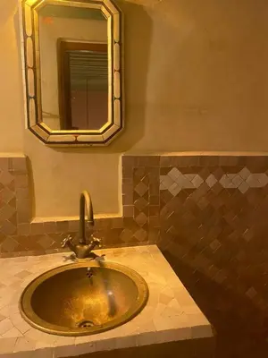 a bathroom with a sink and a mirror at Riad Alfredo in Fès