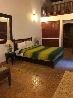 a bedroom with a large bed in a room at Riad Alfredo in Fès