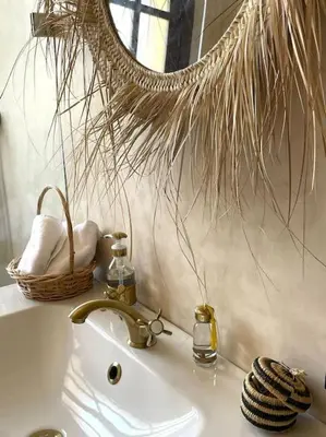 a bathroom sink with a mirror and a basket on it at Dar Amali, villa spacieuse 9ch avec piscine en exclusivité in Marrakech