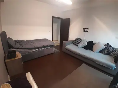 a living room with a couch and a bed at Luxurious apartment city center in Fès
