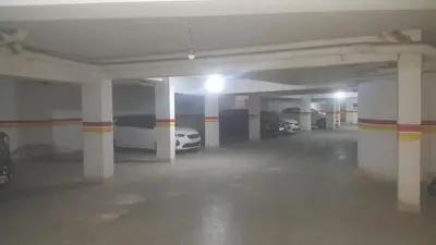 an empty parking garage with two cars parked in it at Luxurious apartment city center in Fès