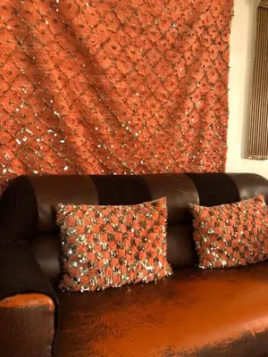 a brown couch with two pillows in a living room at Amina appartement in Azrou