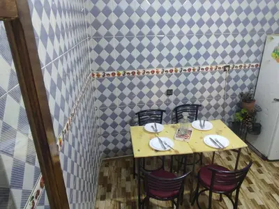 a table with chairs and plates on top of it at Amina appartement in Azrou