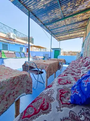 a row of tables in a room with blue ceilings at Riad Basma Fes - Tranquil Getaway in Fès