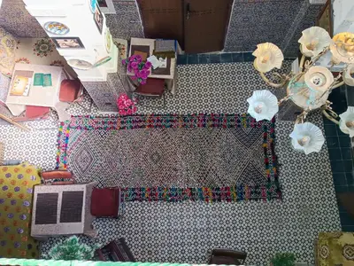 an overhead view of a table with a laptop on it at Riad Basma Fes - Tranquil Getaway in Fès