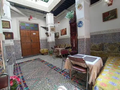 a living room with a couch and a table at Riad Basma Fes - Tranquil Getaway in Fès