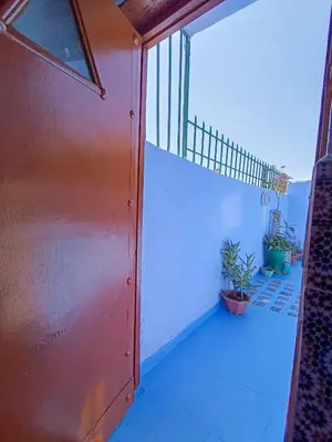 a room with a door and a balcony with plants at Riad Basma Fes - Tranquil Getaway in Fès