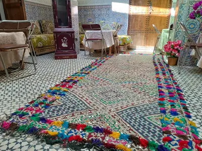 a rug with flowers on the floor in a room at Riad Basma Fes - Tranquil Getaway in Fès