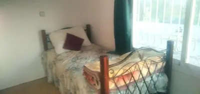 a bedroom with a bed and a window at Dar Fes Marrakech in El Hajeb