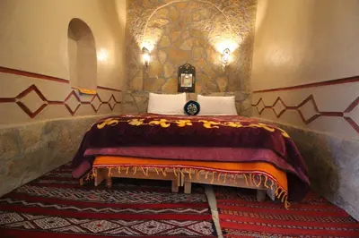 a bedroom with a bed with a blanket on it at Auberge Ibrahim in Agoudal