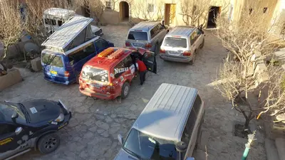 a group of cars parked in a parking lot at Auberge Ibrahim in Agoudal