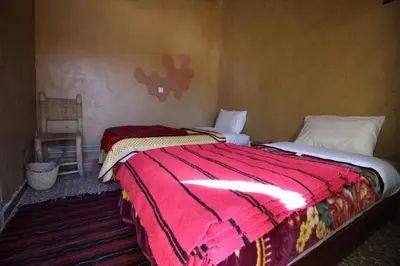 a bedroom with two beds in a room at Auberge Ibrahim in Agoudal