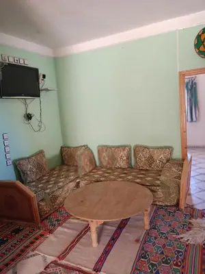 a living room with a couch and a table at Gite Skoura in Caïd Bou Malla