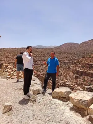 two men standing on top of a mountain at Gite Skoura in Caïd Bou Malla
