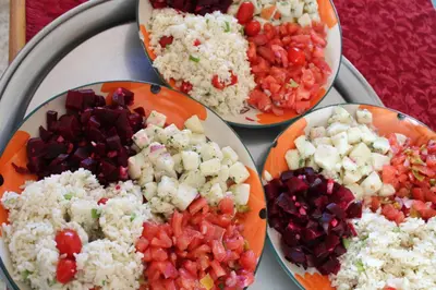 four plates of food on a table with rice and vegetables at Gite Skoura in Caïd Bou Malla