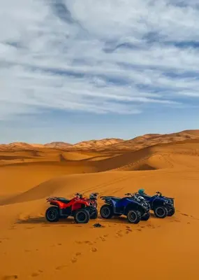 three atvs in the sand in the desert at Sunshine luxury desert camp in Merzouga