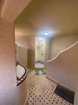 a large bathroom with a shower and a tile floor at Tafsut dades guesthouse stay with locals in Tamellalt