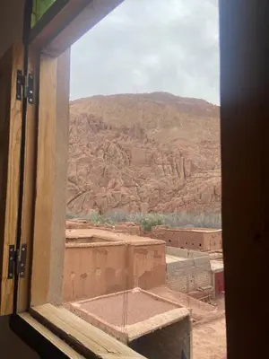 a view of the desert from a window at Tafsut dades guesthouse stay with locals in Tamellalt