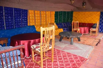 a room with chairs and a table and colorful walls at Riad le Petit Jardin in Zagora