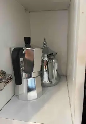a coffee pot sitting on a shelf in a kitchen at Magnifique appartement moderne (avec Wifi) in Fès
