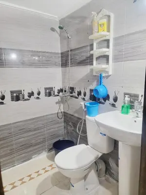 a bathroom with a toilet and a sink at Appartement de luxe Nour in Fès