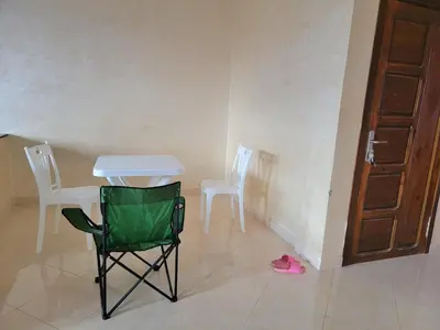 a room with a table and two chairs and a door at Appartement de luxe Nour in Fès