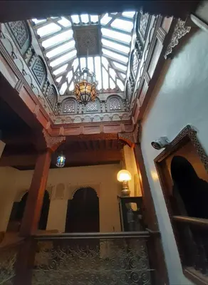 a building with a ceiling with a chandelier at Dar roeya in Fès