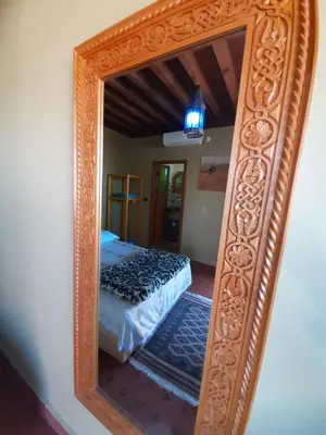 a mirror reflection of a bed in a bedroom at Dar roeya in Fès