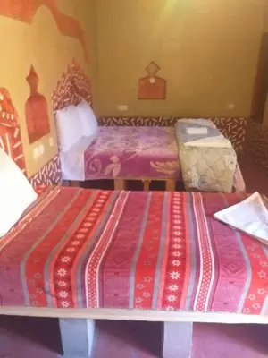 a hotel room with two beds in a room at Kasbah Ifri in Amdnarene