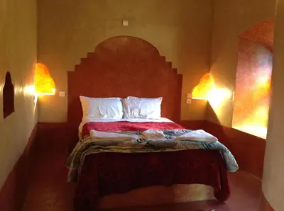 a bedroom with a bed with two pillows at Kasbah Ifri in Amdnarene