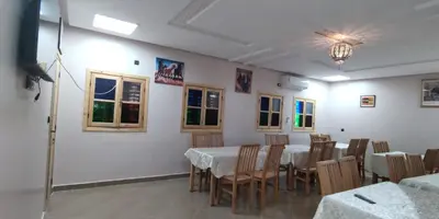 a dining room with tables and chairs and a ceiling at Gite Vanadenite in Midelt