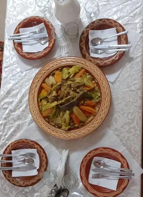 a table with a bowl of food on a table at Gite Vanadenite in Midelt