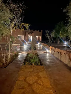 a row of lights in a courtyard at night at Riad Ecobio in Aït Yous