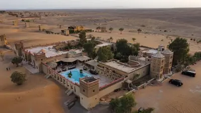 an aerial view of a building in the desert at Hotel Cafe Du Sud in Merzouga