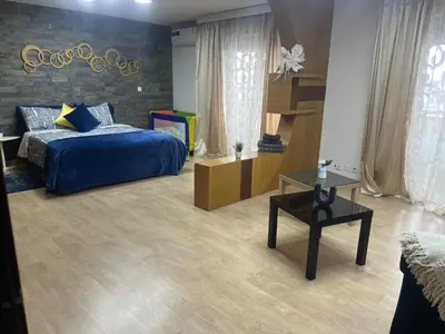 a bedroom with a blue bed and a table at MODERNE APPART PLEIN CENTRE in Fès