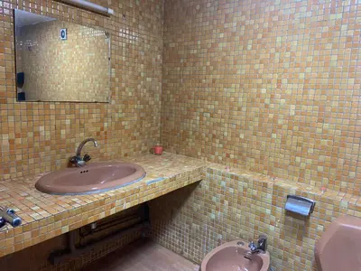 a bathroom with a sink and a mirror and two toilets at MODERNE APPART PLEIN CENTRE in Fès