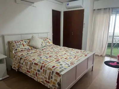 a bedroom with a large bed with a colorful comforter at MODERNE APPART PLEIN CENTRE in Fès