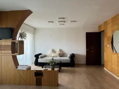 a living room with a couch and a tv at MODERNE APPART PLEIN CENTRE in Fès