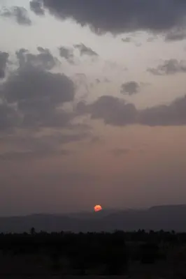 a sunset in the sky with the sun in the distance at Land of dreams in Nkob
