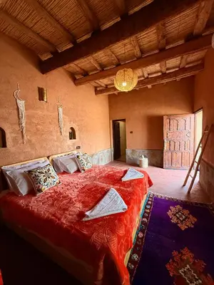 a bedroom with a large red bed in a room at Land of dreams in Nkob