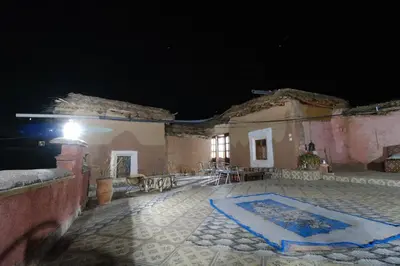 a night view of a building with a patio at Gite Timit la maison Imazghn in Azilal