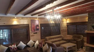 a living room with a couch and a chandelier at Chez karim in Ifrane