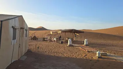 a building in the middle of the desert at Epic Erg Chigaga Desert Camp in El Gouera