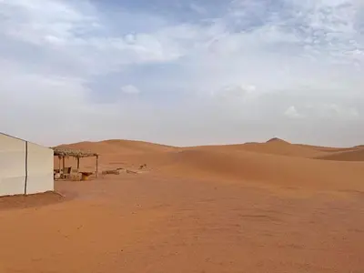 a building in the middle of the desert at Epic Erg Chigaga Desert Camp in El Gouera