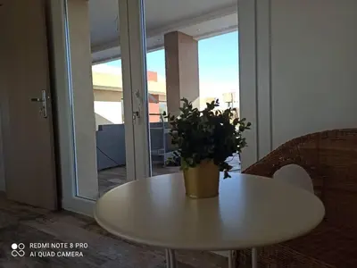 a white table with a potted plant on top of it at Bienvenu chez VillAtlas in Marrakech