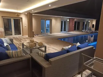 a living room with a swimming pool with couches at Bienvenu chez VillAtlas in Marrakech