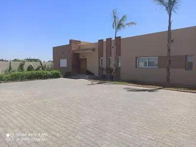 a brick parking lot in front of a building at Bienvenu chez VillAtlas in Marrakech