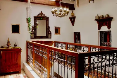 a room with a wooden railing and a mirror at DAR Naima in Fès